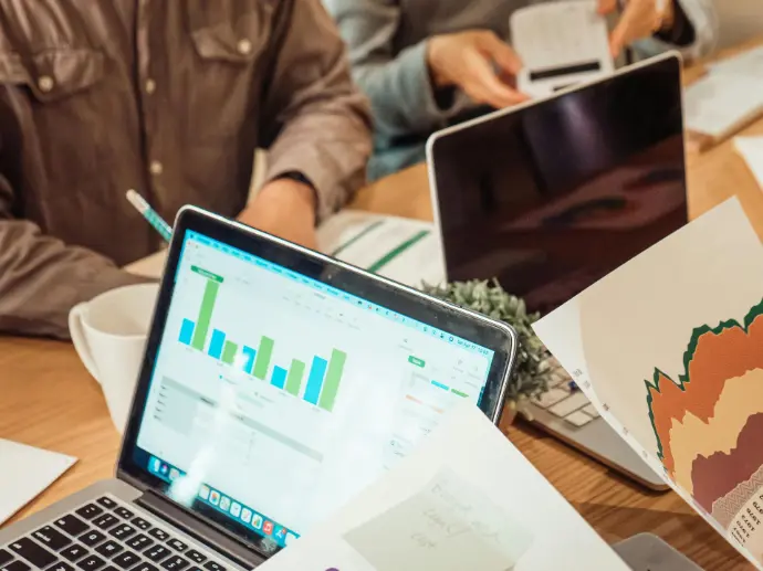 Viewing Business Reports for Insights In-depth business report, showcasing the use of digital tools to analyze business performance. This visual highlights the integration of technology in accessing and interpreting business data for strategic decision-making.